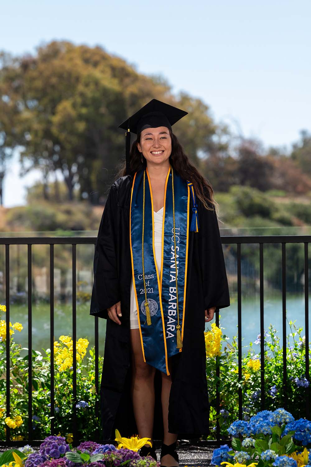 A 2021 graduate wearing regalia.