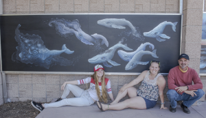 Artist Loni Marineau and Arts & Culture committee members in front of mural