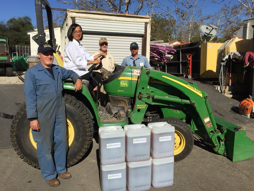 HDAE staff in front of biodiesel tractor.