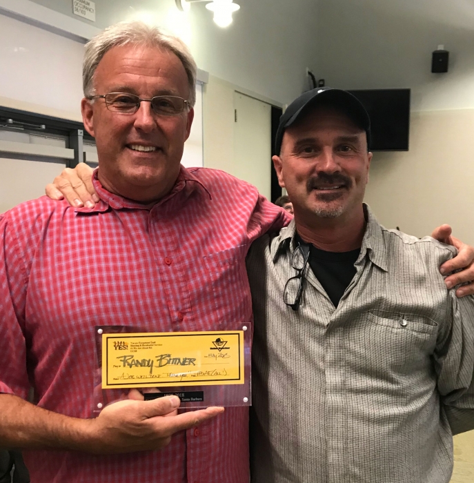 Randy Bittner was recognized by Eric Zobel at his retirement party for the creation of the Housing YES Value Voucher.