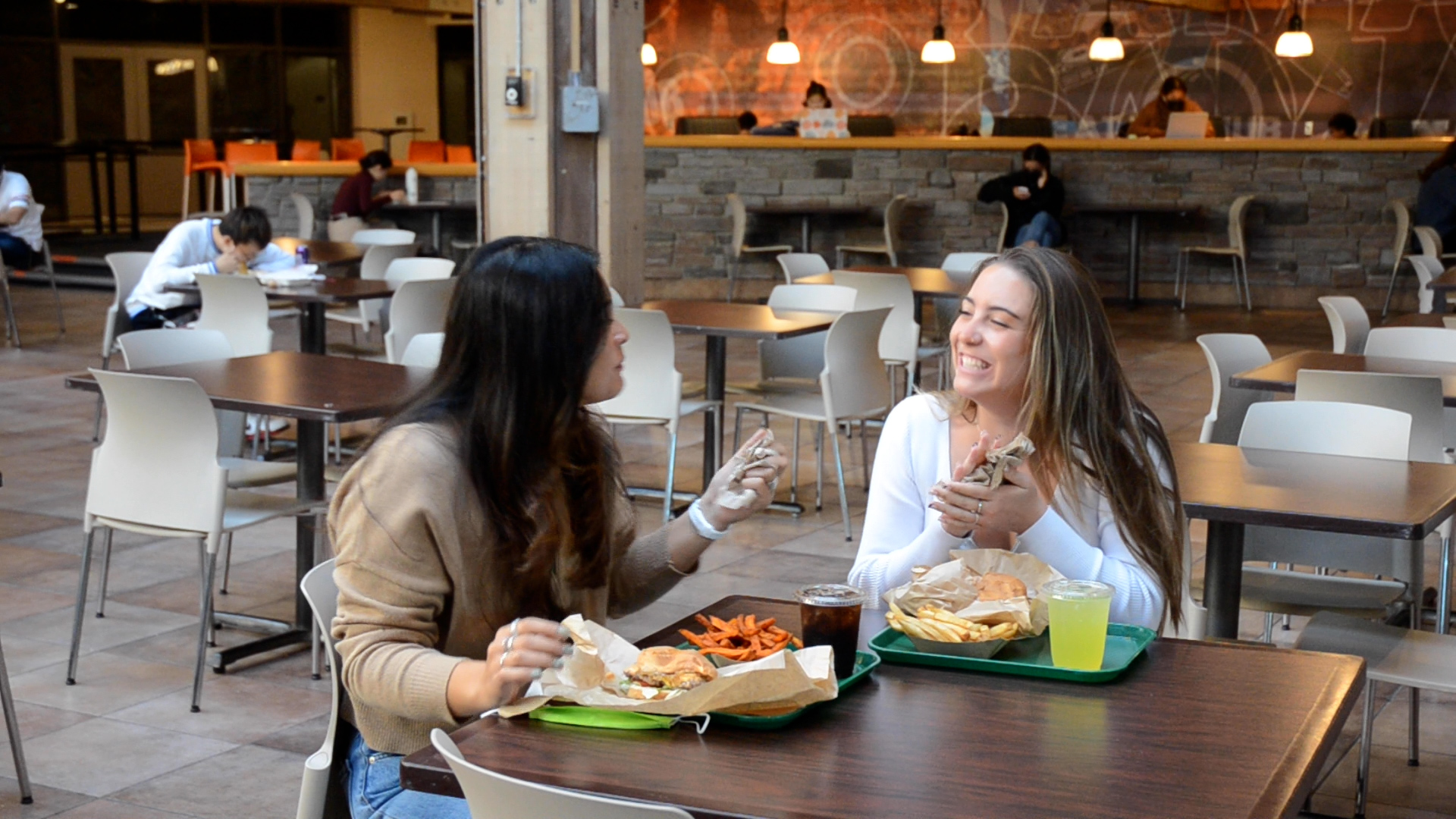 Student enjoying burgers.