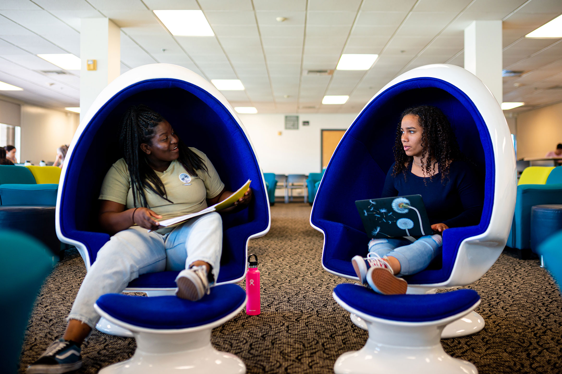 two ucsb students sitting in egg chairs in santa catalina
