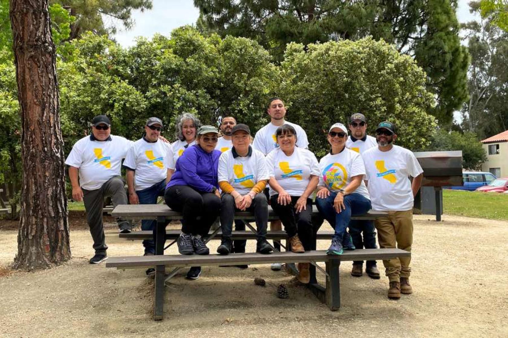 HDAE Staff member group photo sitting on a picnic table